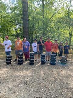 Scouts Standing Behind Cast Iron Dutch Ovens Full of Fresh Cobblers