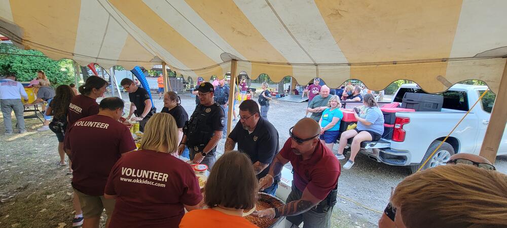 Volunteers serving OK Kids BBQ Dinner 