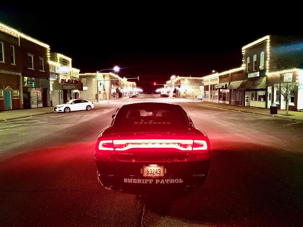 Patrol Car with Holiday Lights in Background