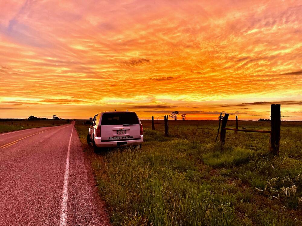 Patrol Vehicle on Side of Road in Sunset